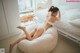 A woman laying on a bean bag chair in a bedroom.